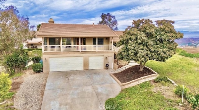 view of front of home with a balcony and a garage