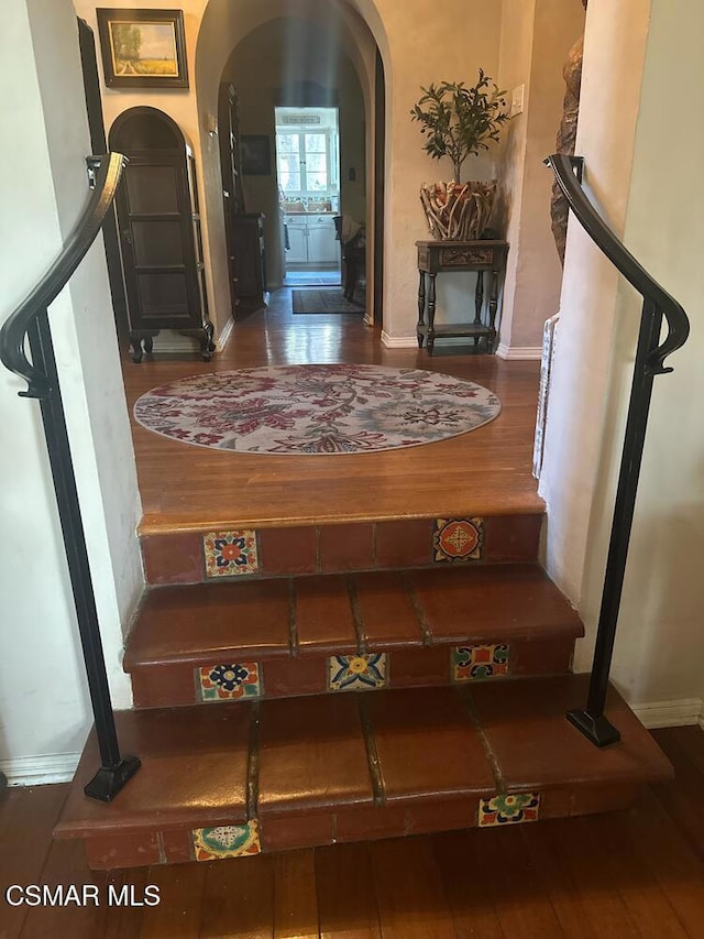 staircase featuring wood-type flooring