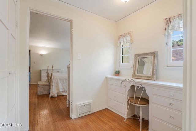 bathroom with ornamental molding and hardwood / wood-style floors