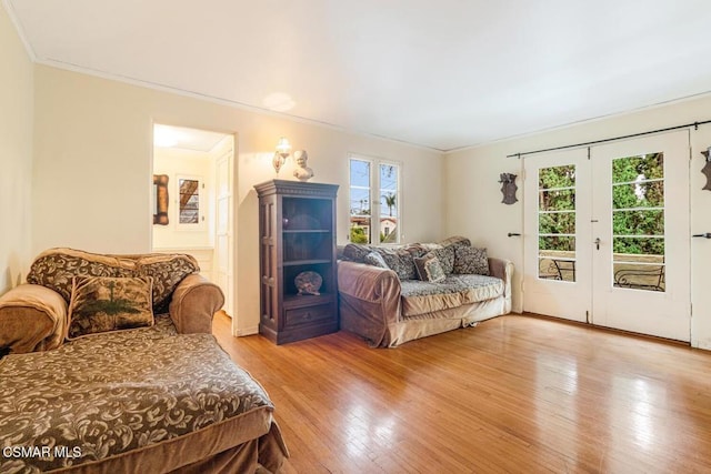 bedroom with access to exterior, hardwood / wood-style flooring, ornamental molding, and french doors