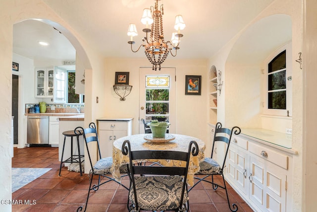 tiled dining area with an inviting chandelier