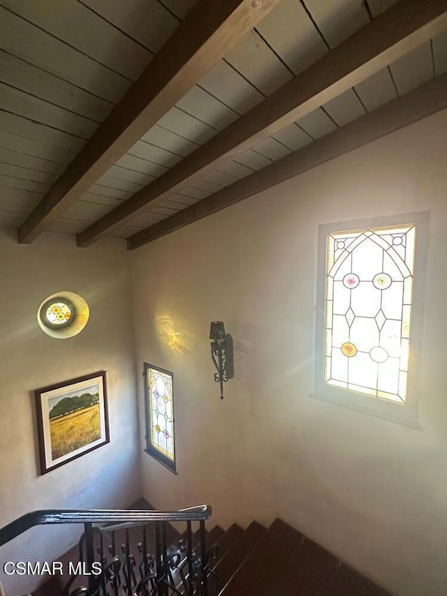 stairway featuring vaulted ceiling with beams and wooden ceiling