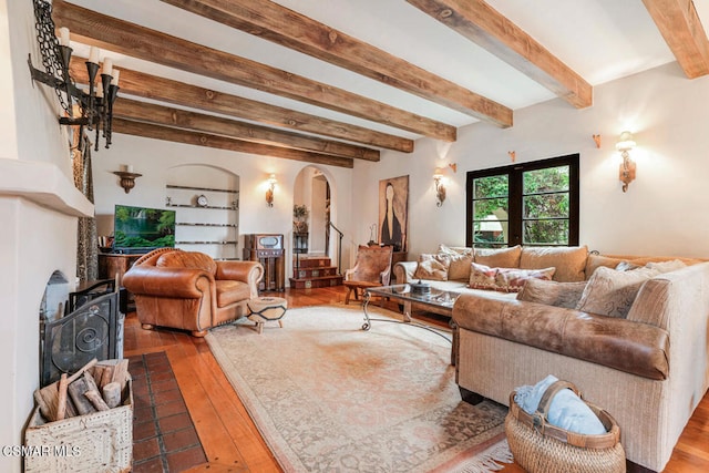 living room featuring beamed ceiling and wood-type flooring