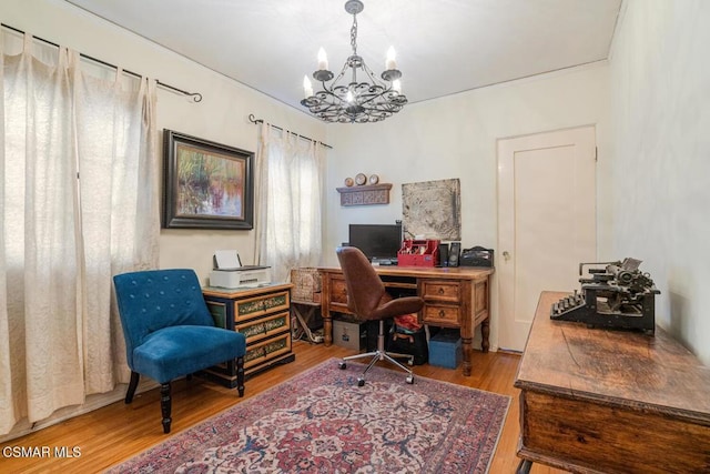 home office with wood-type flooring and a chandelier