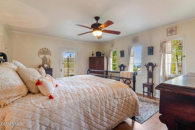 bedroom featuring hardwood / wood-style flooring, crown molding, access to outside, and ceiling fan