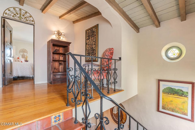 stairway with hardwood / wood-style flooring, wood ceiling, and beamed ceiling