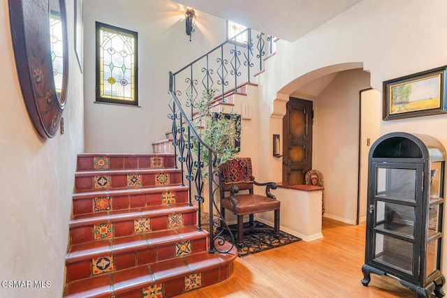 staircase with hardwood / wood-style flooring