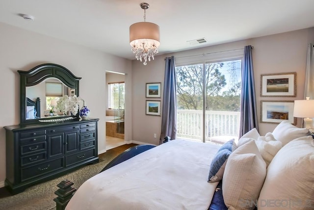 carpeted bedroom featuring a notable chandelier, ensuite bathroom, and access to exterior