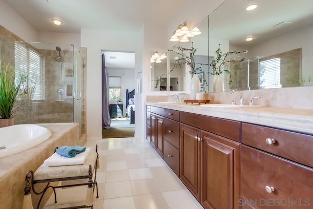 bathroom featuring vanity and shower with separate bathtub