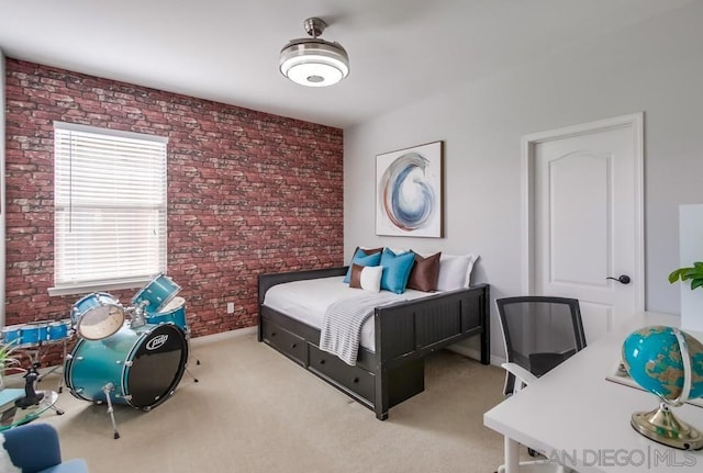 bedroom featuring light colored carpet and brick wall