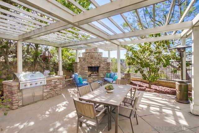 view of patio / terrace featuring exterior kitchen, grilling area, a pergola, and an outdoor stone fireplace