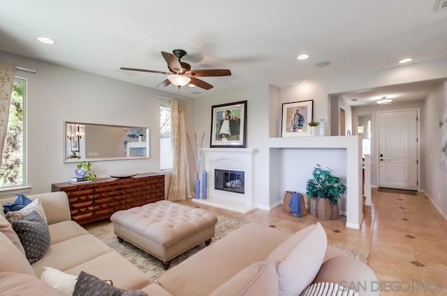 living room with light tile patterned flooring and ceiling fan