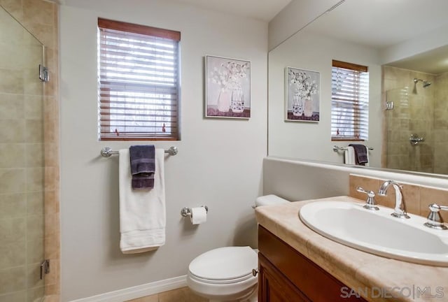 bathroom with vanity, toilet, and a shower with shower door