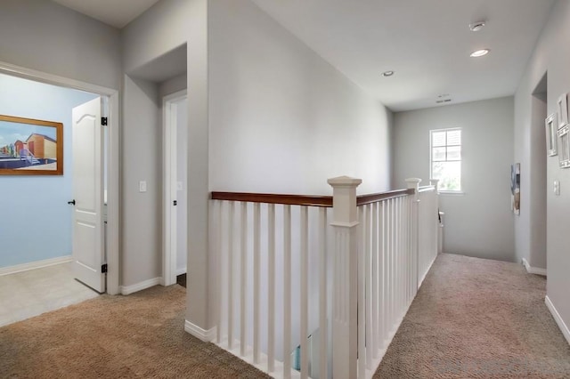 hallway featuring light carpet