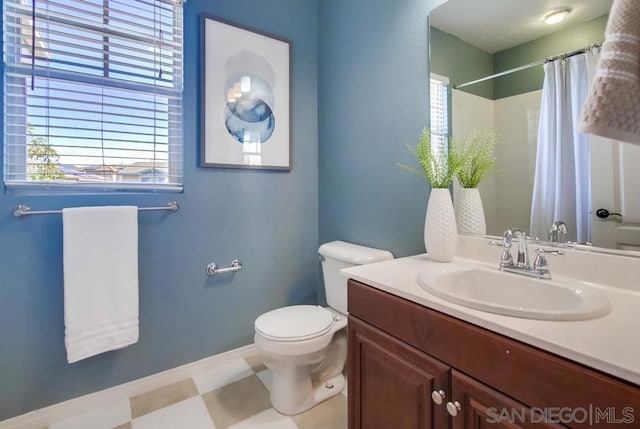 bathroom featuring vanity, toilet, and walk in shower