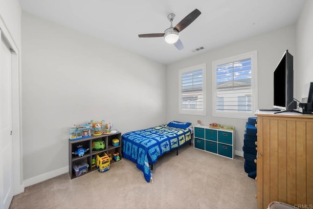 bedroom with ceiling fan and light colored carpet