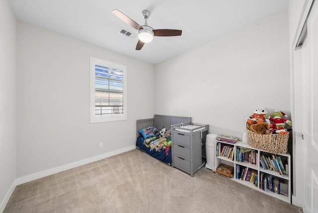 recreation room featuring ceiling fan and light colored carpet