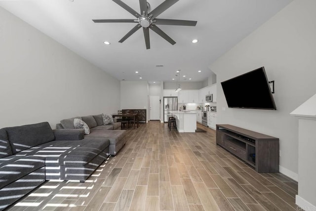 living room with sink and ceiling fan