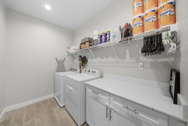 laundry area with cabinets and washing machine and clothes dryer