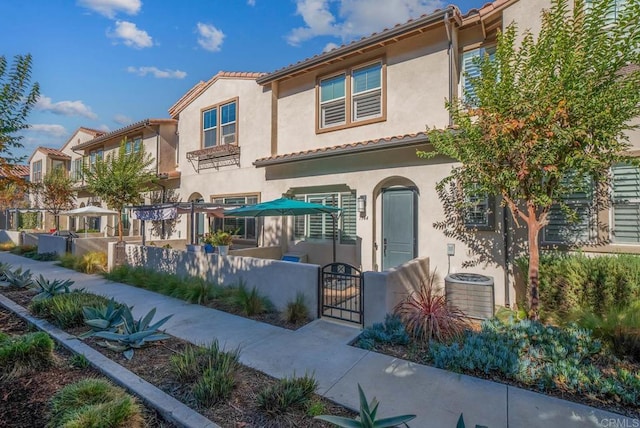 mediterranean / spanish-style house featuring central AC unit