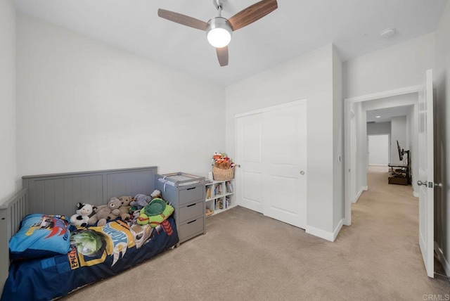 bedroom with ceiling fan and light carpet