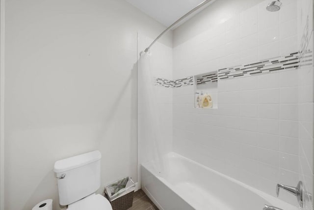 bathroom featuring shower / tub combo with curtain and toilet