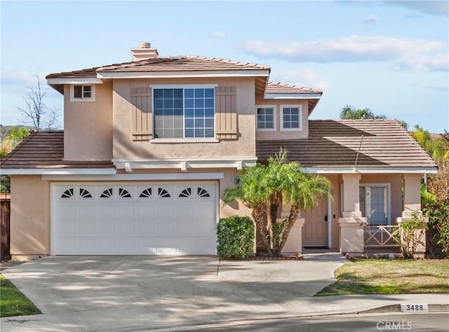 view of front of home with a garage, concrete driveway, a tile roof, a chimney, and stucco siding