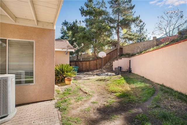 view of yard featuring a fenced backyard and central AC