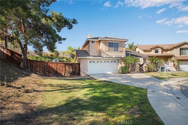 traditional-style home featuring a front yard, fence, driveway, and stucco siding