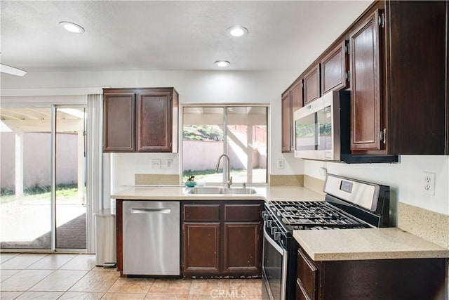 kitchen with light countertops, appliances with stainless steel finishes, plenty of natural light, and a sink