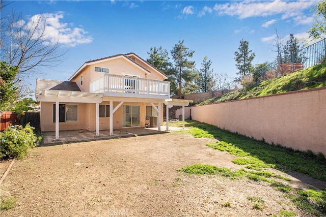 back of house with a patio area, a fenced backyard, a wooden deck, and stucco siding