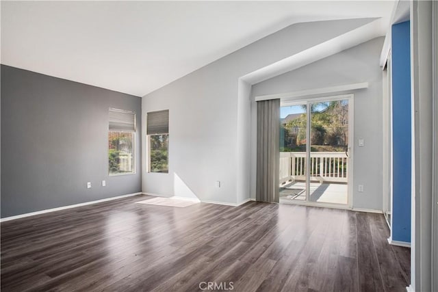 unfurnished room with dark wood-type flooring, lofted ceiling, and baseboards