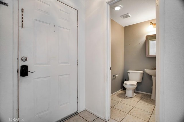 bathroom with visible vents, tile patterned flooring, toilet, and baseboards