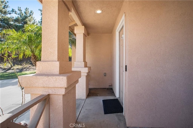 entrance to property featuring stucco siding