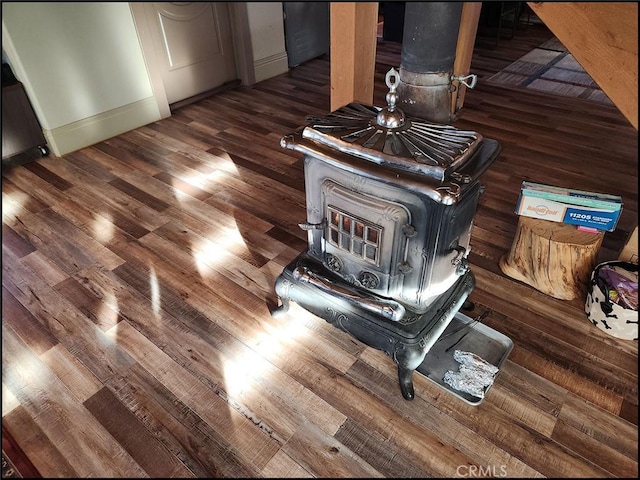 room details with wood-type flooring and a wood stove