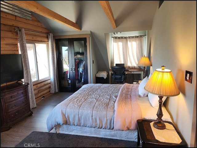 bedroom with dark hardwood / wood-style floors and lofted ceiling with beams