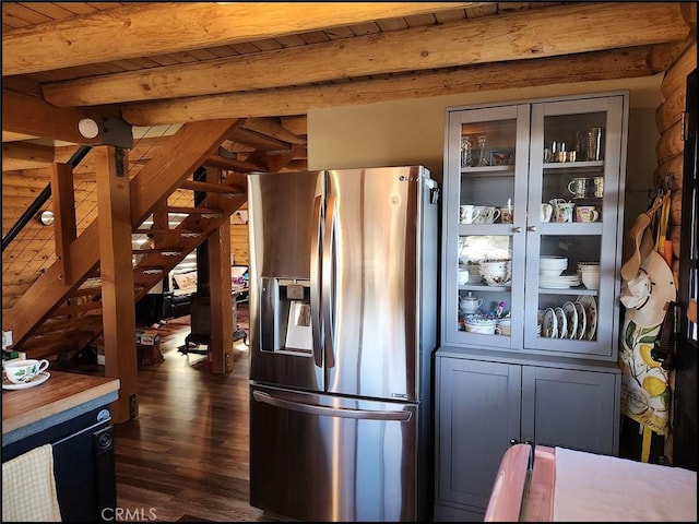 kitchen with beam ceiling, wood ceiling, dark hardwood / wood-style floors, and stainless steel refrigerator with ice dispenser