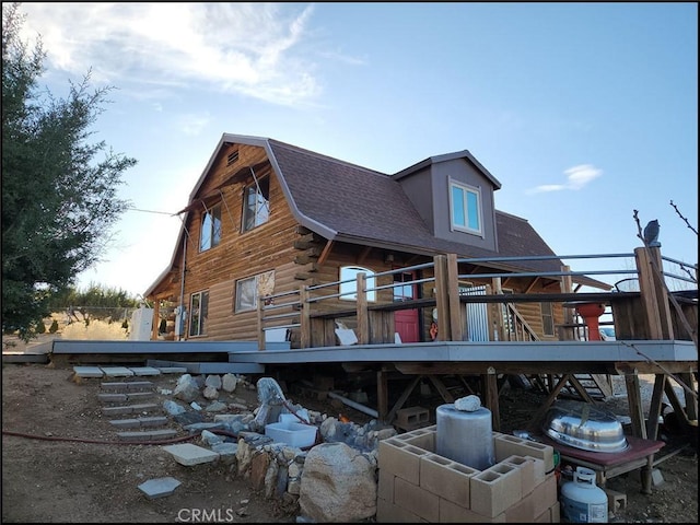 rear view of property featuring a deck