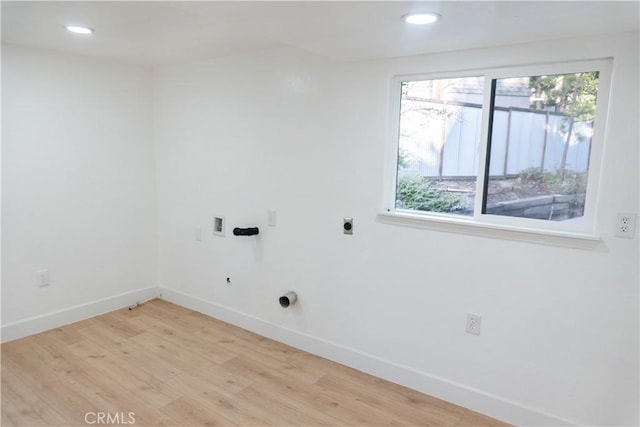 laundry room featuring hookup for a washing machine, light hardwood / wood-style flooring, and electric dryer hookup