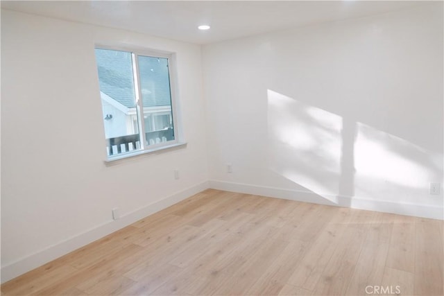 spare room with light hardwood / wood-style floors