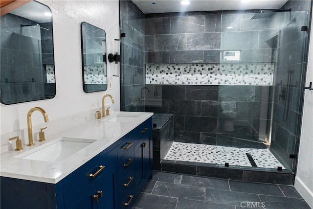 bathroom featuring tiled shower and vanity