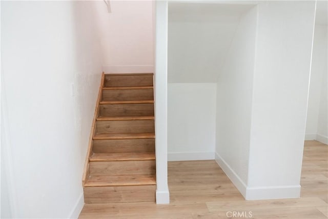 stairs featuring wood-type flooring