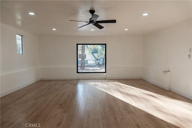 unfurnished room with hardwood / wood-style flooring and ceiling fan