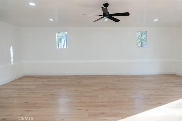 unfurnished room featuring ceiling fan, plenty of natural light, and light hardwood / wood-style flooring