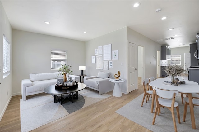 living room with a wealth of natural light and light wood-type flooring