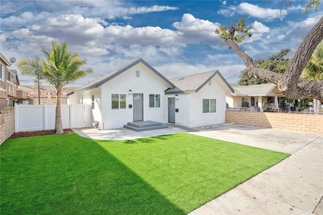 view of front of property with a patio area and a front lawn