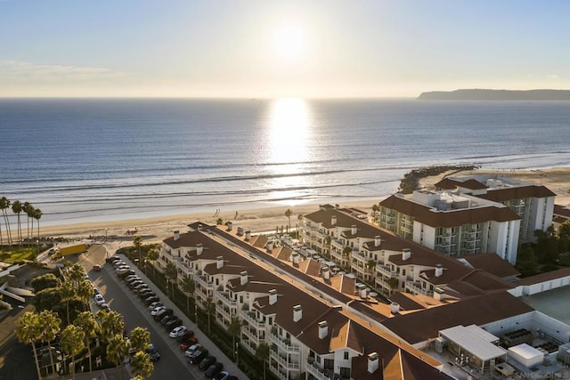 birds eye view of property featuring a beach view and a water view