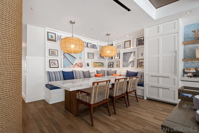 dining area with crown molding, dark hardwood / wood-style flooring, and breakfast area