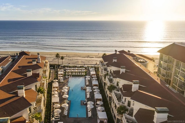 birds eye view of property featuring a view of the beach and a water view