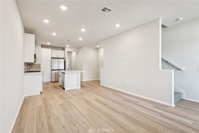 2720 Crozier Ct, Pomona, CA 91767 - unfurnished living room featuring light wood-style flooring, recessed lighting, baseboards, and stairway